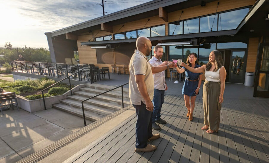 Photo of people toasting their drinks on a patio on the Kitsap Peninsula