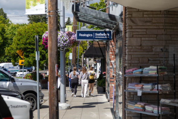 Photo of young women walking on sidewalk while shopping on Bainbridge