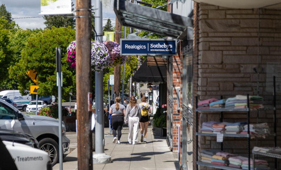 Photo of young women walking on sidewalk while shopping on Bainbridge