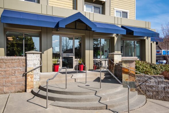 Exterior entrance of Marshall Suites Bainbridge Island, SureStay Collection by Best Western, with covered entry and landscaped approach on Bainbridge Island, Washington.