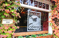 Photo of Pegasus Coffee House sign on exterior window of the coffee shop