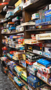 A large shelf filled with a variety of board games at Ashley's Pub in Bremerton, WA, offering a wide selection for game enthusiasts.