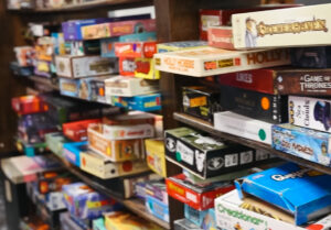Wall-to-wall shelves stacked with colorful board games at Ashley’s Pub in Bremerton, a popular board game bar and hangout spot.
