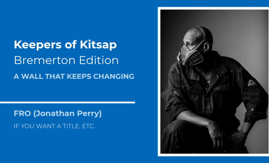 Black-and-white portrait of Bremerton artist FRO, Jonathan Perry, wearing a respirator and work clothes for the Keepers of Kitsap: Bremerton Edition artist profile.